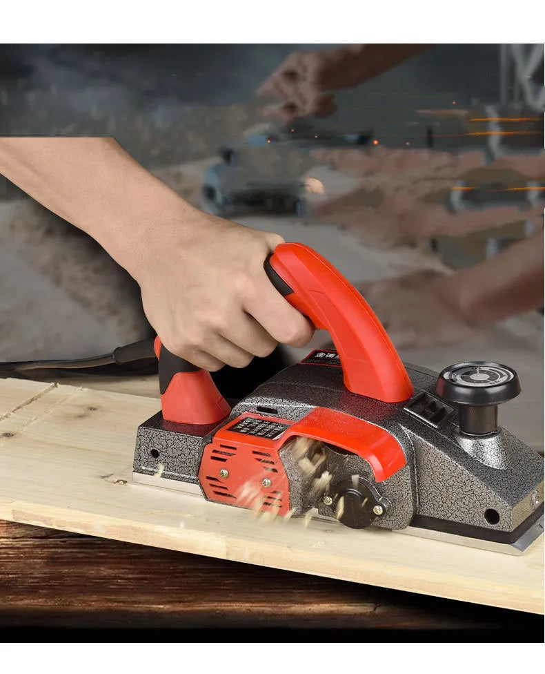 Red desktop electric wood planer with aluminium shell showing 82mm cutting width