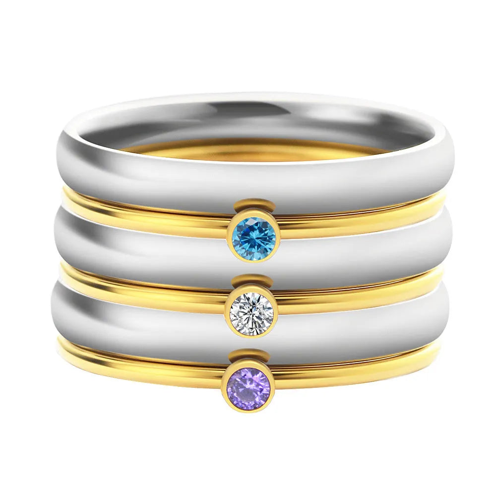 Close-up of a geometric titanium steel ring with December birthstone and engraved pattern, shown in one of three colour options.