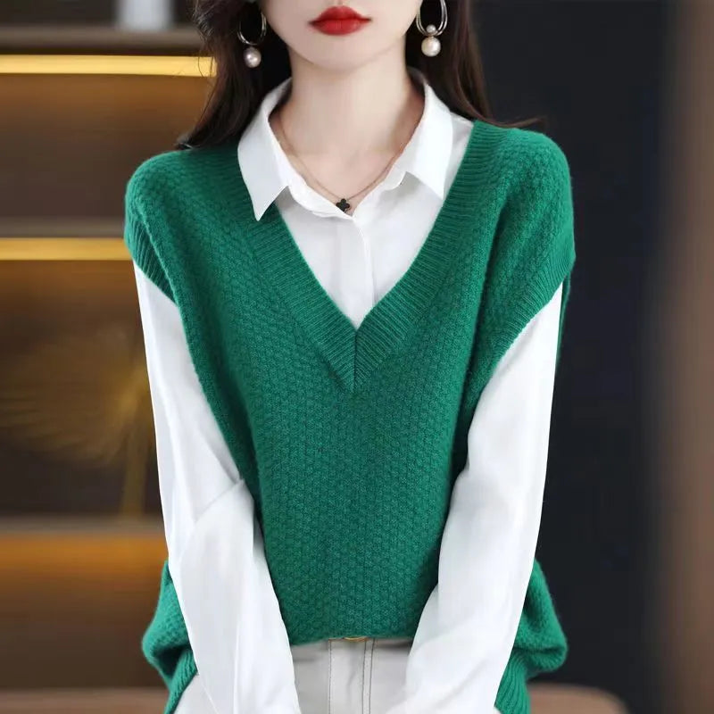 Women's creamy-white V-neck sleeveless knitted vest with a textured 3D pattern on a hanger.