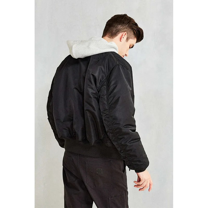 Men's loose fit army green nylon pilot jacket with cotton padding on a mannequin.
