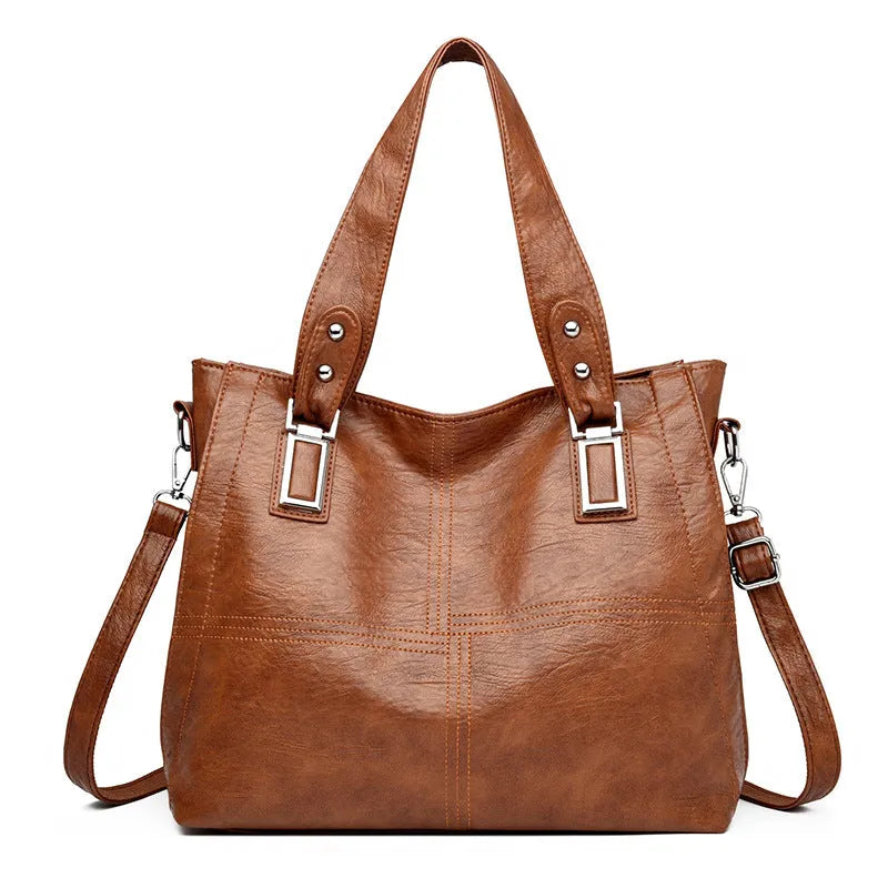 Women's soft PU handbag in horizontal square shape with sewing thread detail and single shoulder strap.