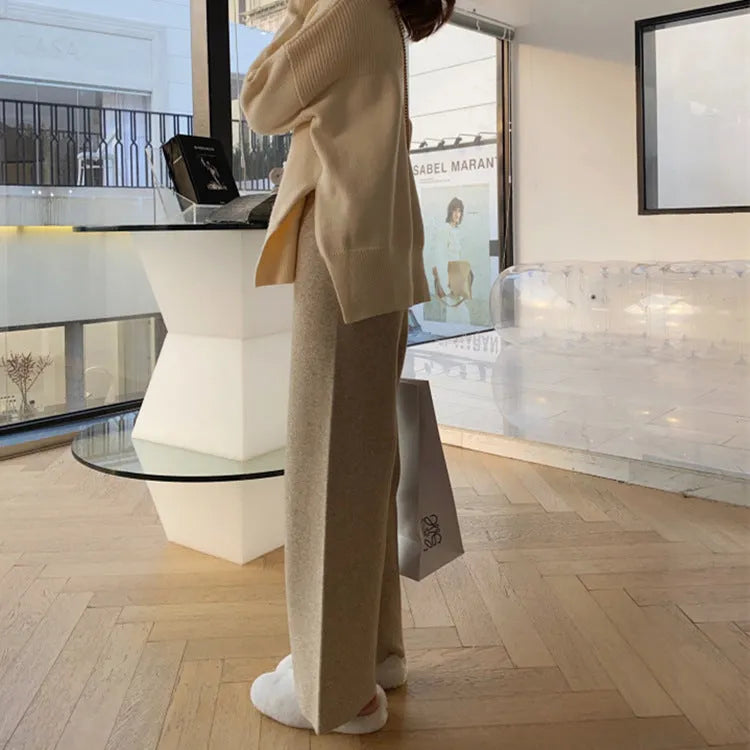 Women's high-waist knitted wide-leg trousers in a cream white colour, showcasing the straight-leg mopping style.