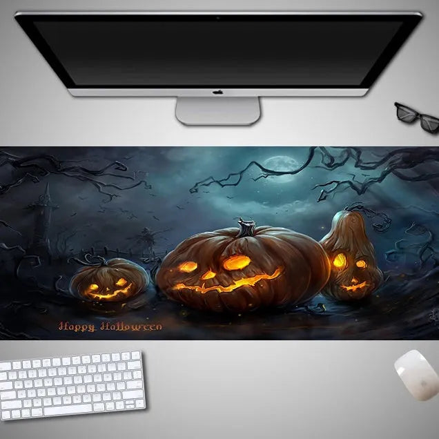 Oversized Halloween graphic cloth mouse pad on a desk, showing non-slip rubber base.
