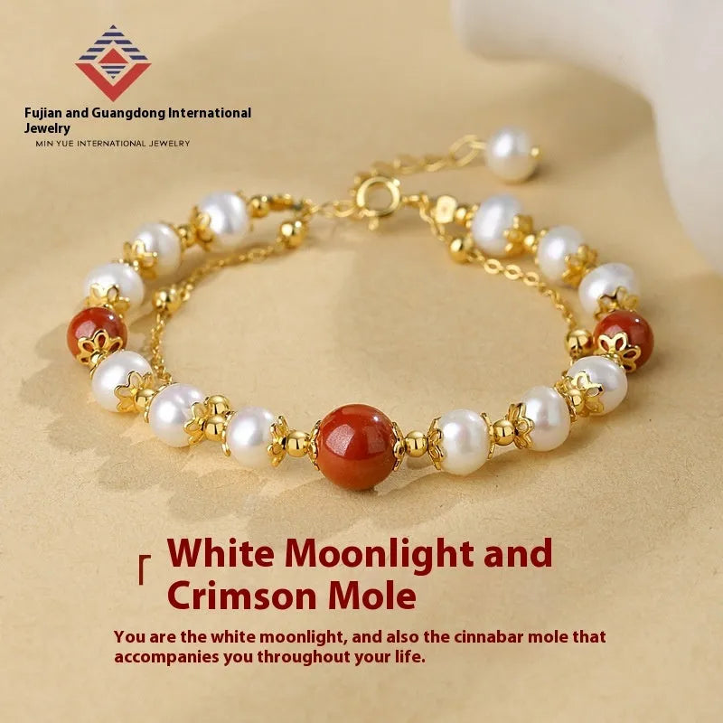 Sterling silver double-layer bracelet with cinnabar red bean and freshwater pearl beads, electroplated finish, geometric bean shape on white background