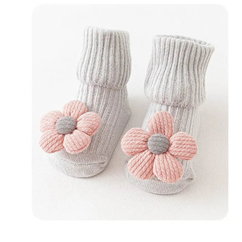 Cotton baby floor socks in various colours and patterns with size guide for ages 0-3 months