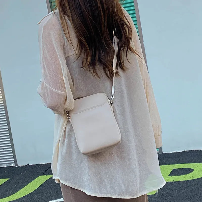 Solid colour PU leather mobile phone crossbody shoulder bag shown in beige.