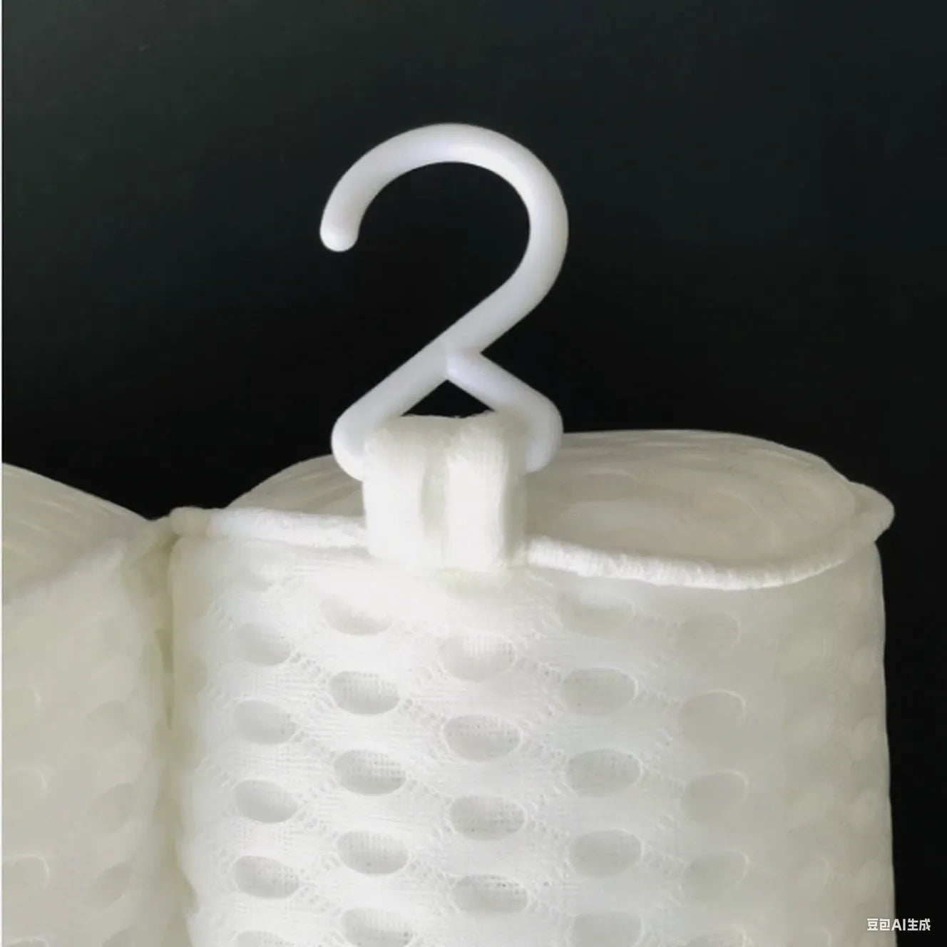 White 3D bathtub pillow with mesh fabric and suction cups on a bathtub edge.
