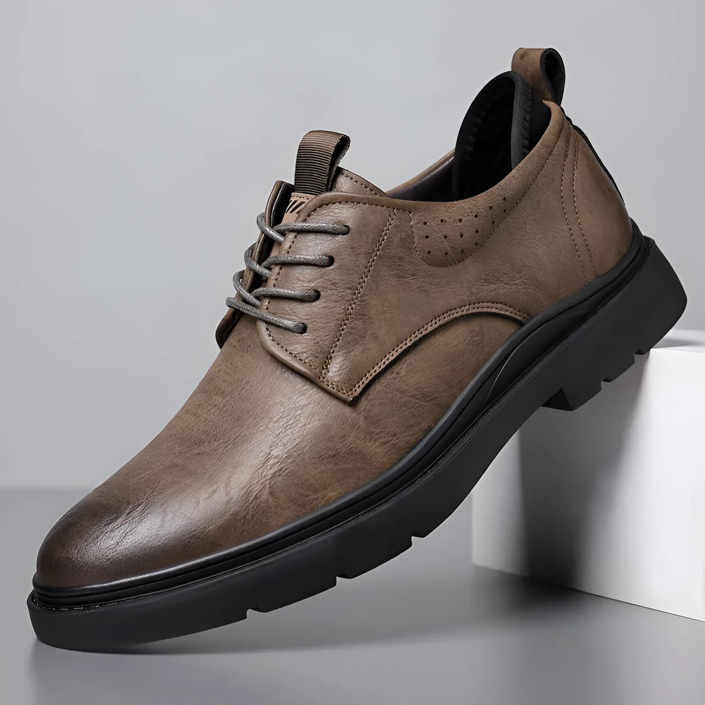 Men's black and brown leather sneakers with rubber sole and decorative sewing line detailing on cowhide upper