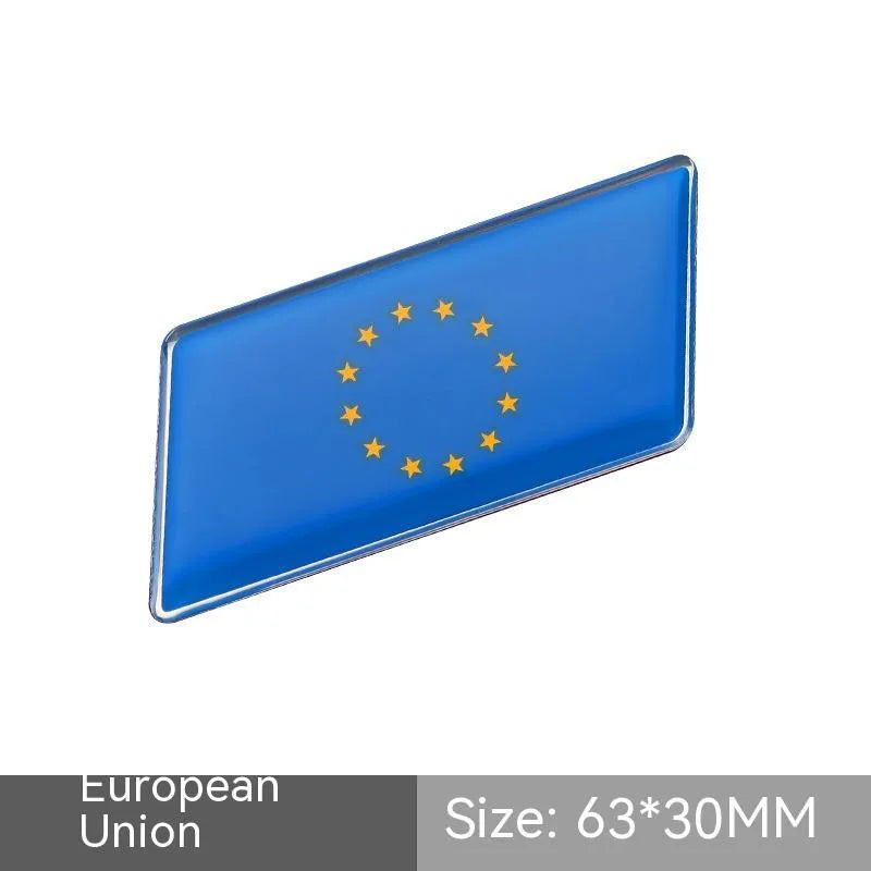 Aluminium parallelogram car sticker showing a national flag design, measuring 6.3 by 3 centimetres.