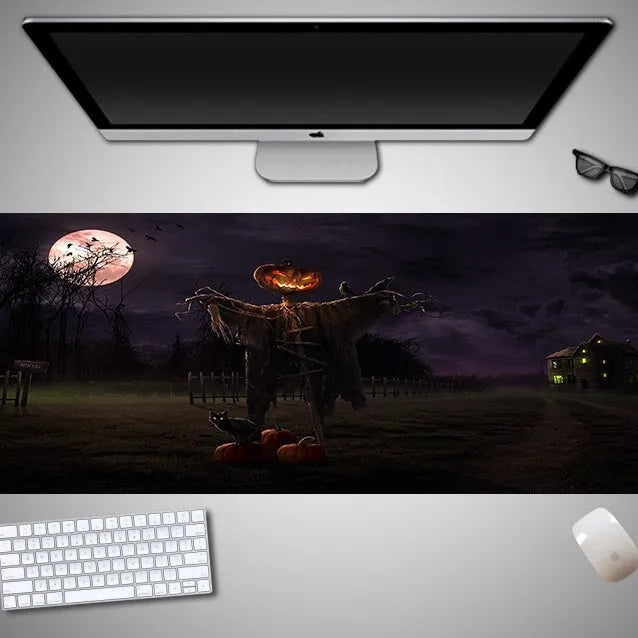 Oversized Halloween graphic cloth mouse pad on a desk, showing non-slip rubber base.