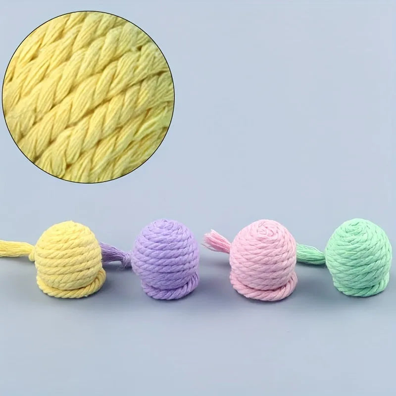 Cat toy ball with rope in four colours: green, pink, purple, and yellow