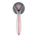 Grey self-cleaning slicker brush for grooming cats and dogs on a wooden table.