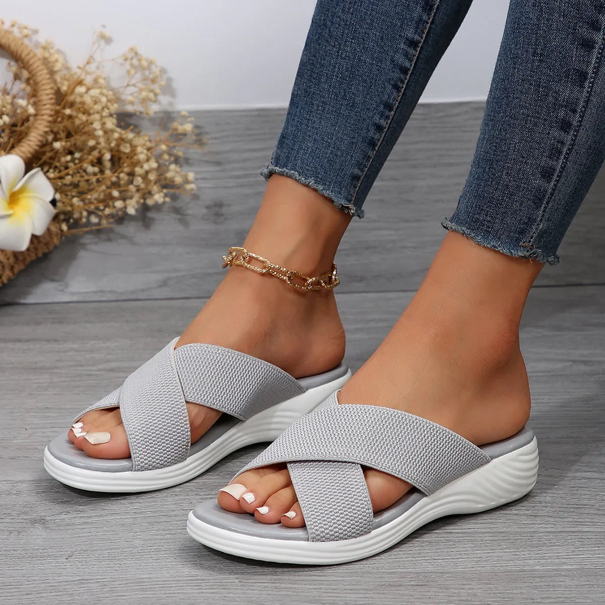 Women's black flat wedge slippers with peep-toe design and cross-strap detailing
