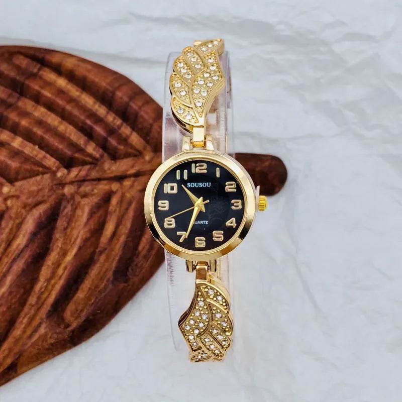 Women's stainless steel watch with round dial on wrist, showing Vachette clasp.