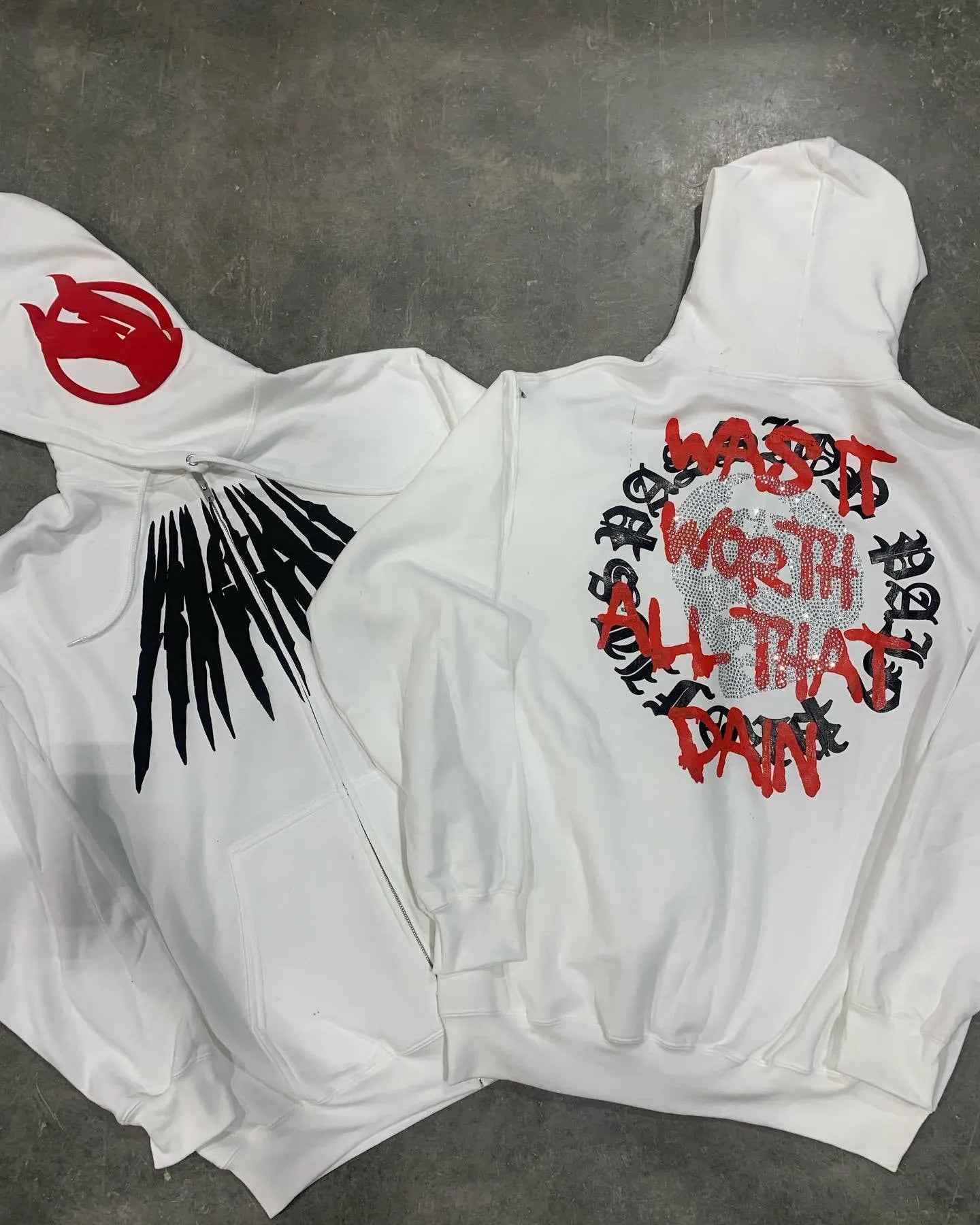 Black hooded sweatshirt cardigan with printed skull pattern and rhinestone detailing