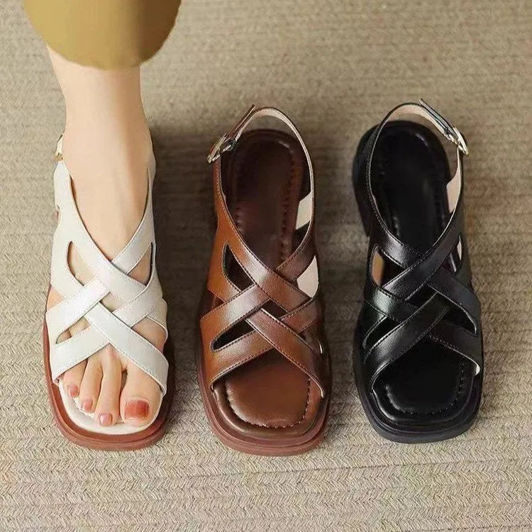 Women's glossy patent leather sandals with square toe and cross ankle strap in black, white, or brown.