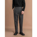 Man wearing grey straight leg polyester trousers for a smart casual look.