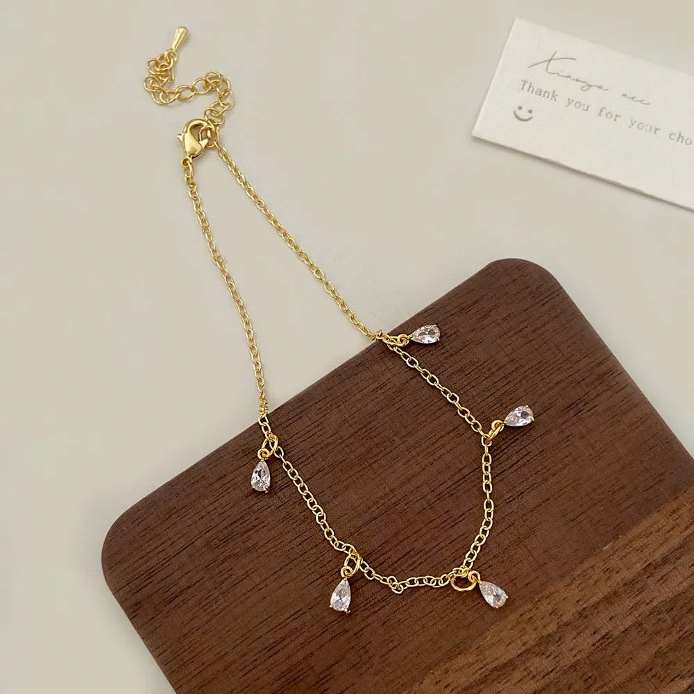 Zircon necklace, earrings, and anklet set with geometric meteor shower design on a regular chain.