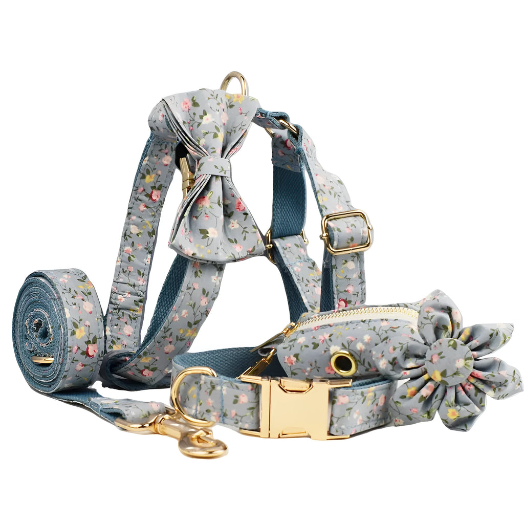 Blue floral patterned cloth dog collar and leash set with matching vest and bow accessories.