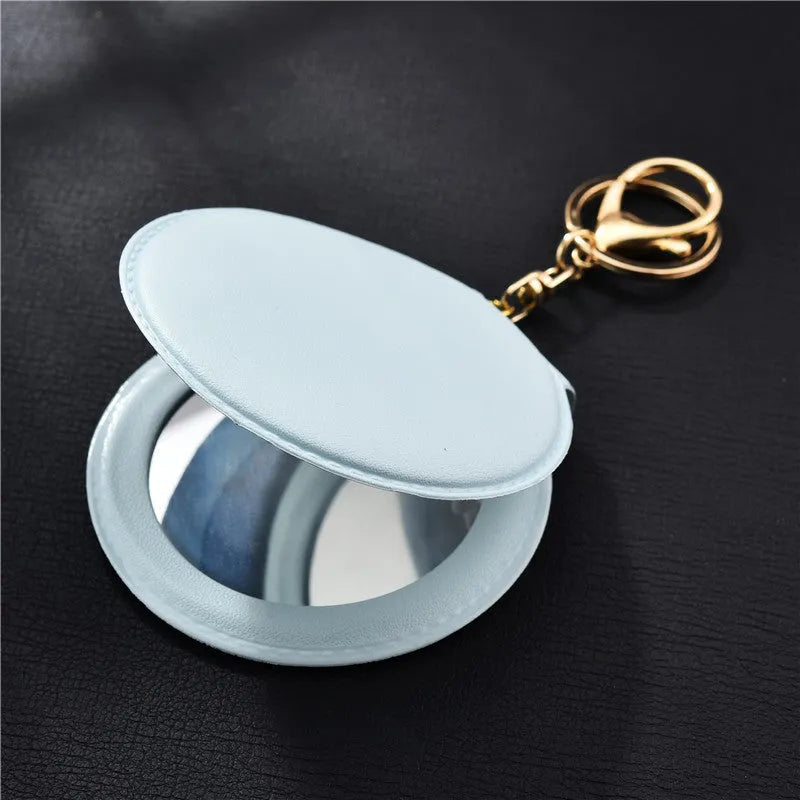 Compact round ladies leather makeup mirror with 8cm diameter glass surface and golden buckle