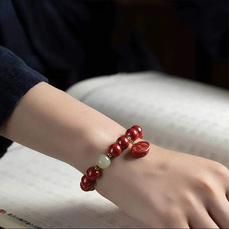 Natural cinnabar bracelet with Ping An Fu Lu design on 8mm or 10mm beads.