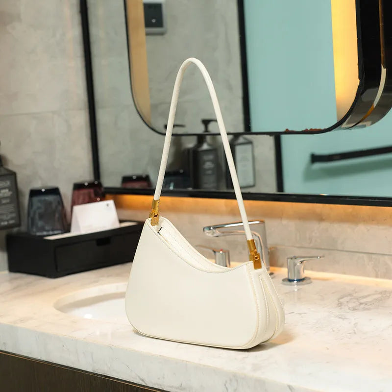 Women's retro oval underarm bag in PU with single strap and internal zip compartment, shown in multiple colour options