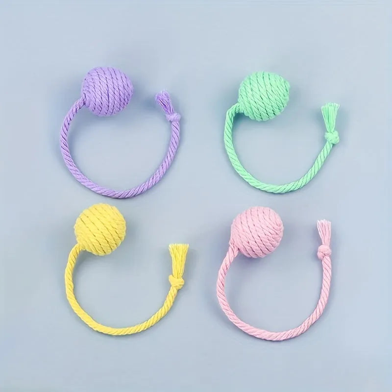 Cat toy ball with rope in four colours: green, pink, purple, and yellow