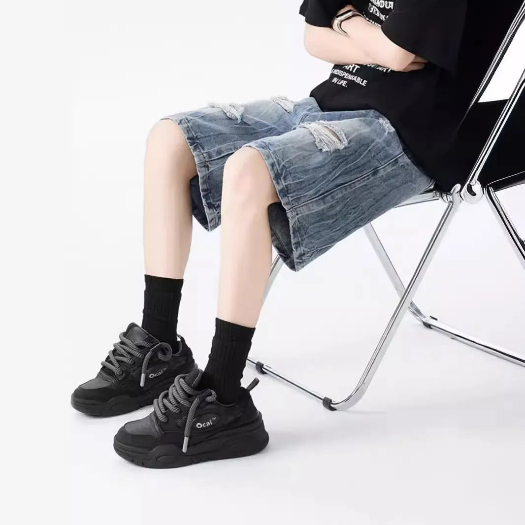 Women's washed denim shorts with ripped detailing in loose retro fit, shown in black and blue colour options