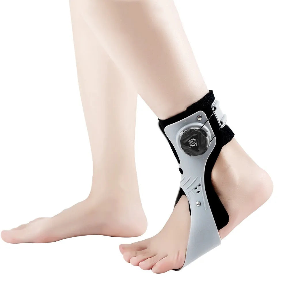 Grey ankle support brace showing airbag button system and hook-and-loop fastening for adjustable compression