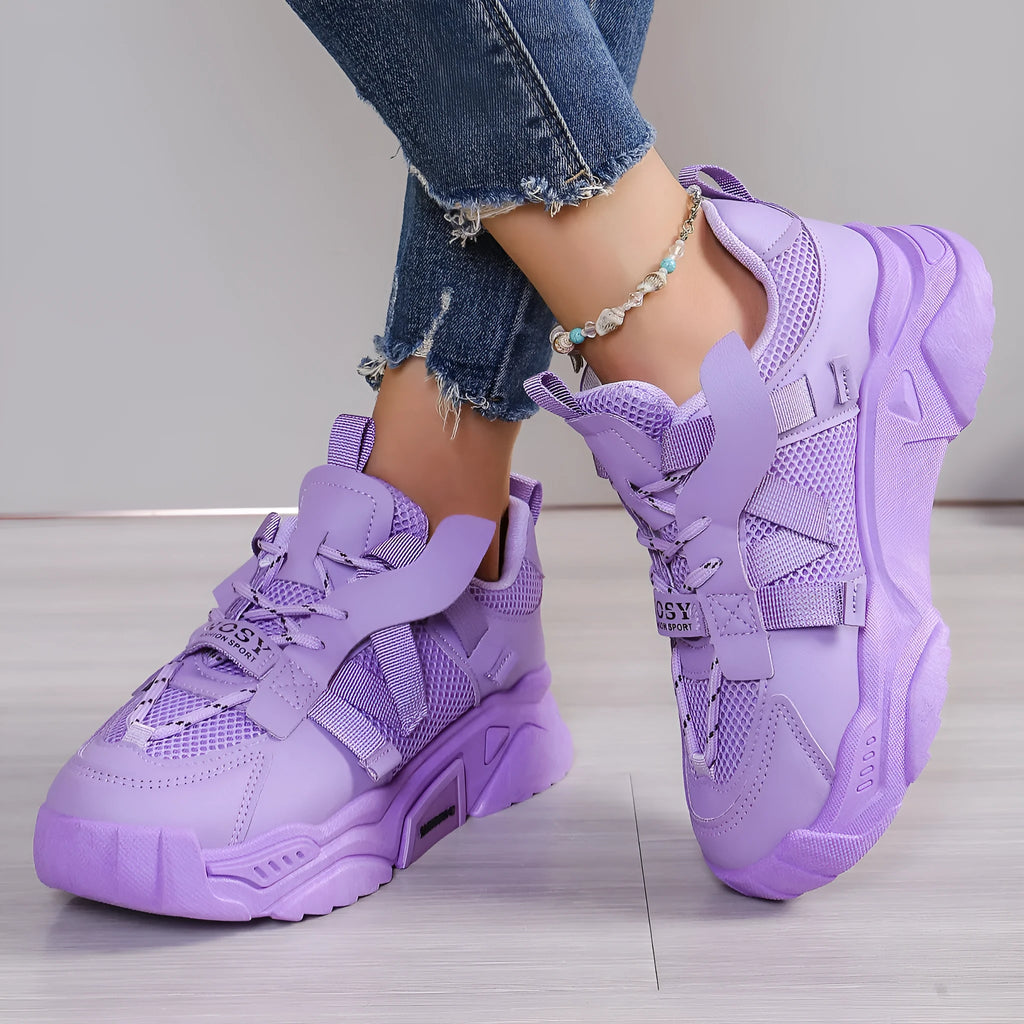 Women's platform mesh dad sports trainer in animal pattern, showing lace-up front and height-increasing sole.