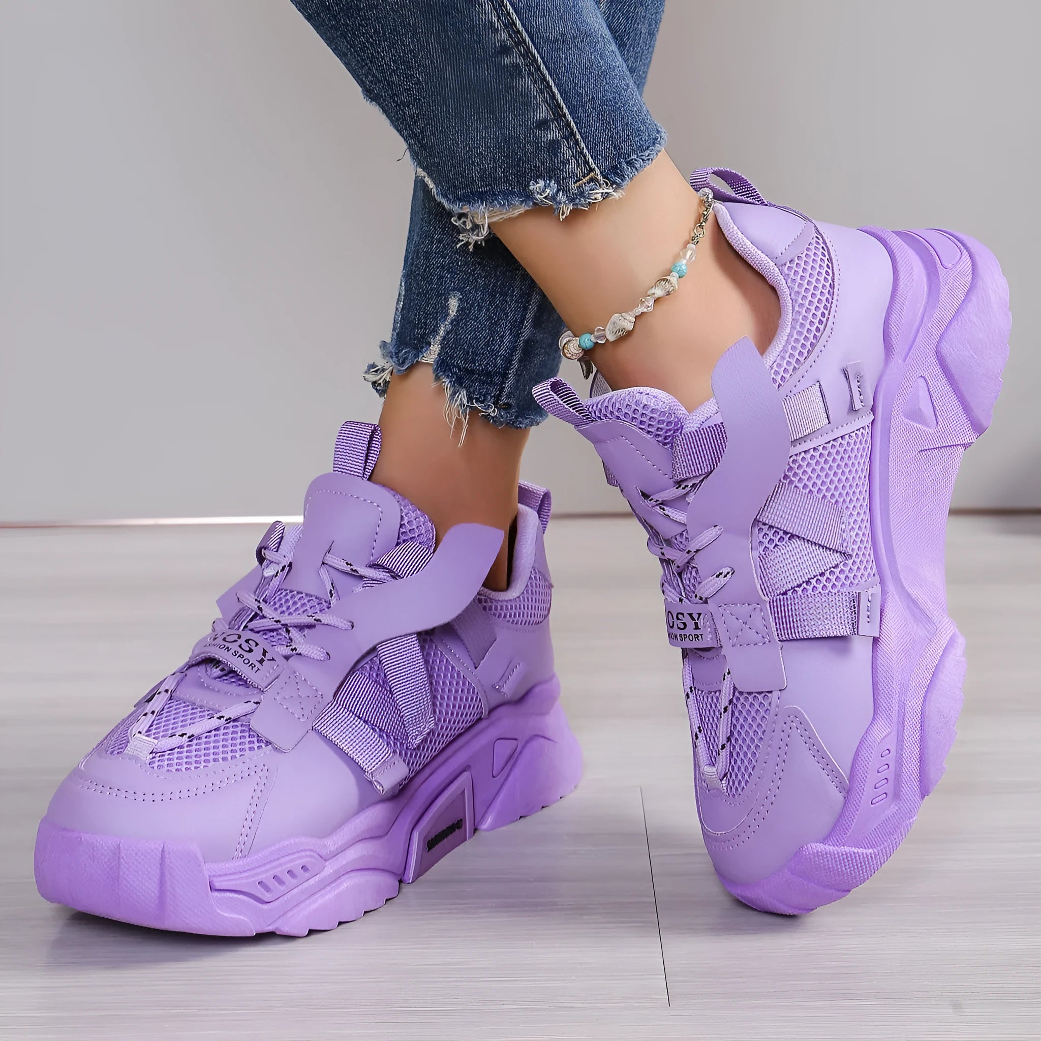 Women's platform mesh dad sports trainer in animal pattern, showing lace-up front and height-increasing sole.