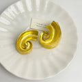 A pair of retro-style geometric ear studs in either gold or silver finish, measuring 5cm.