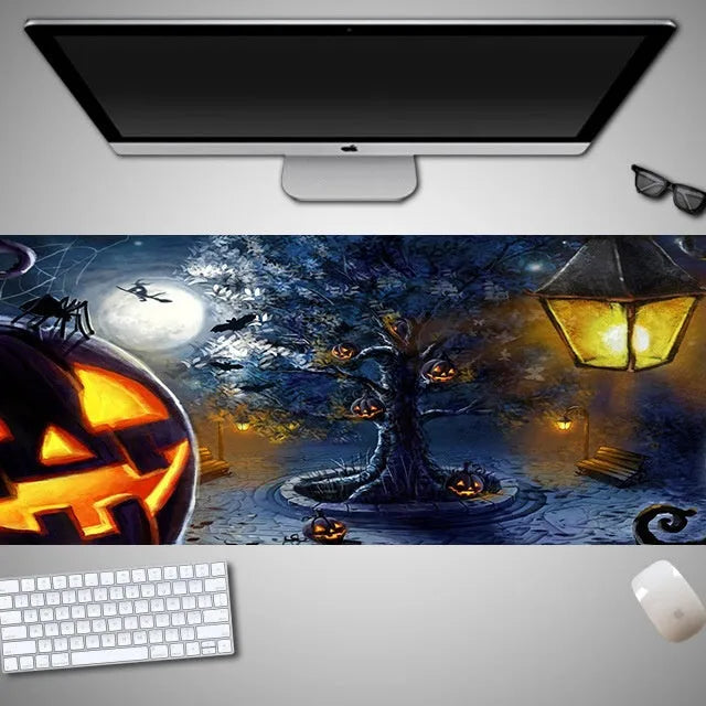 Oversized Halloween graphic cloth mouse pad on a desk, showing non-slip rubber base.