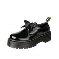 Women's black leather shoes with thick soles, ribbon cross straps, and lacing closure