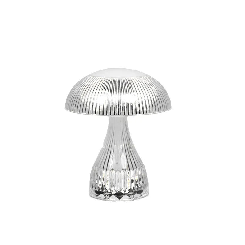 Small white rechargeable touch night lamp with acrylic body and plastic base on a wooden table.
