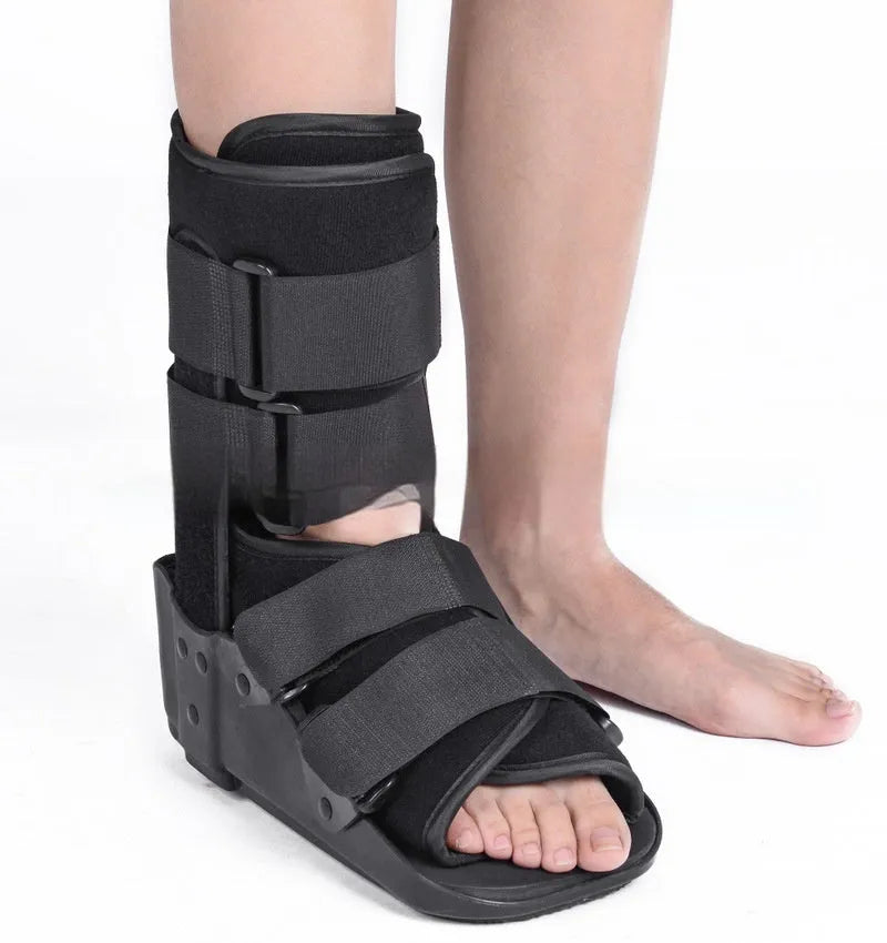 Achilles tendon rehabilitation walking boot in grey colour with adjustable strapping and rocker sole