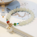 8mm natural Hetian gray jade round bead bracelet on women's wrist, retro style