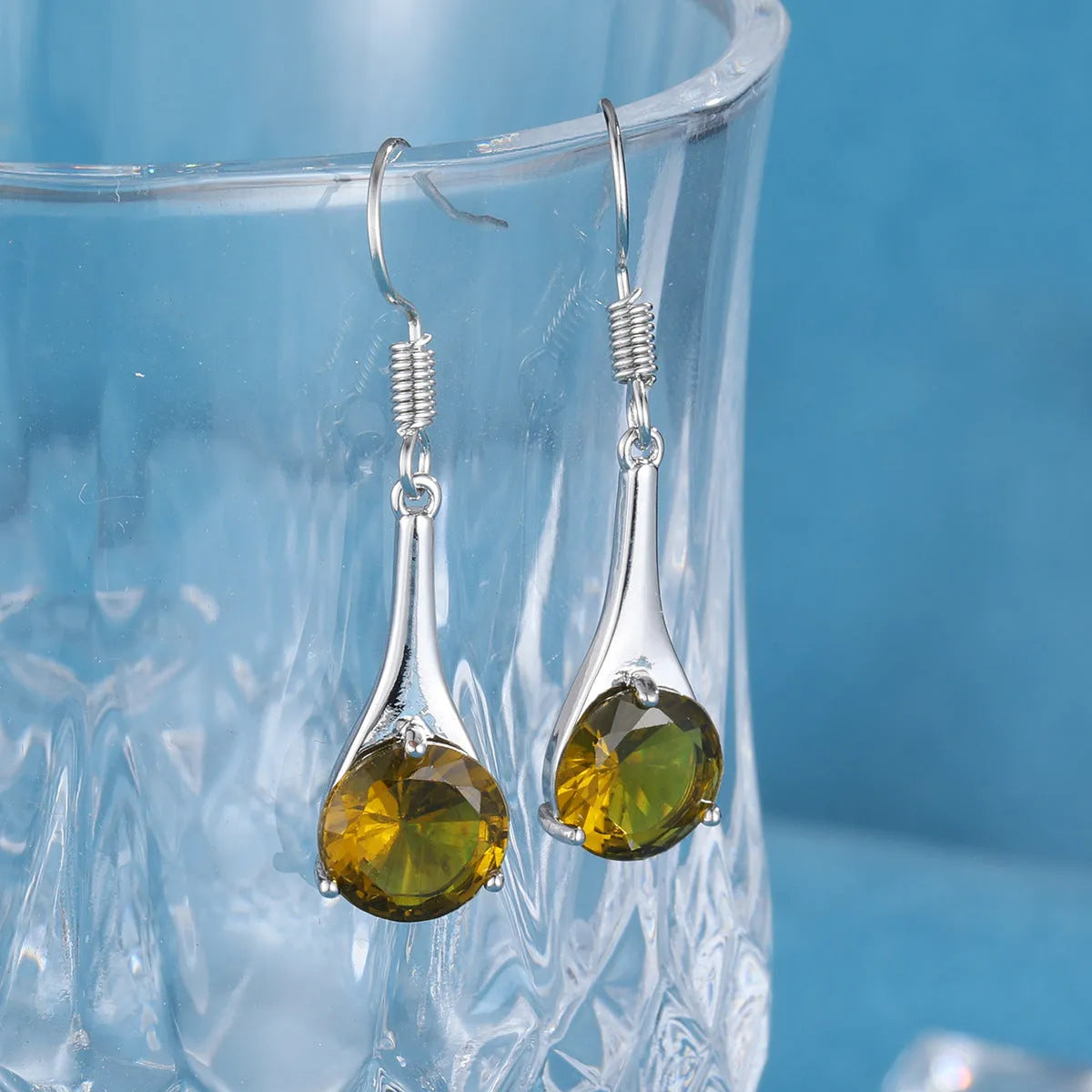 Olive green water drop shaped retro earrings with minimalist design on alloy base