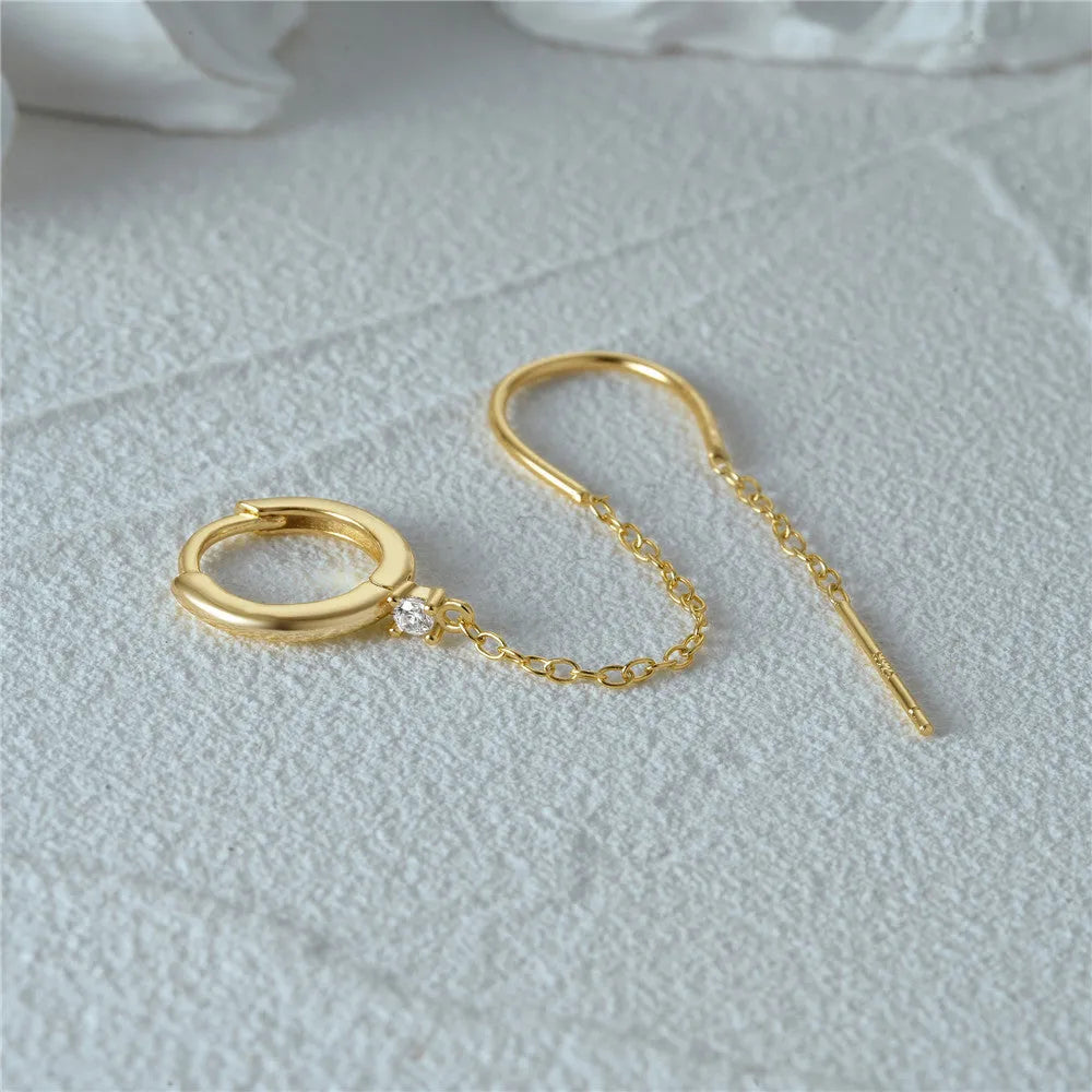 S925 sterling silver stud earrings with a floral motif and dangling gold-coloured tassel chain.