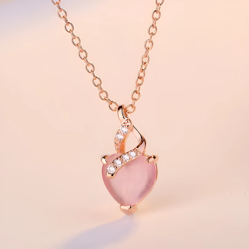 Women's heart-shaped pink crystal pendant with rose gold electroplated finish and matching cross chain