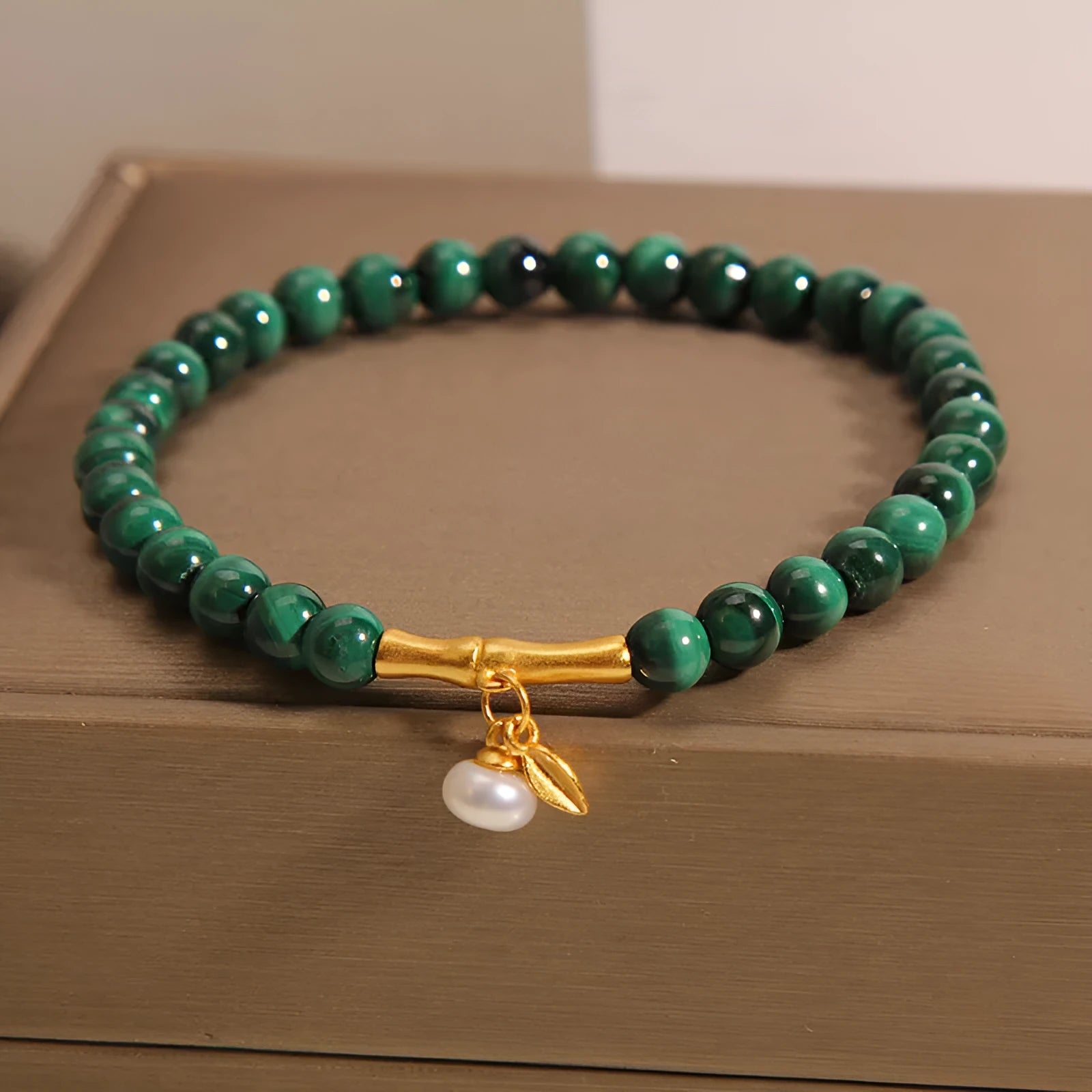Women's white crystal bracelet with a high-rise lucky bamboo design on a wrist.