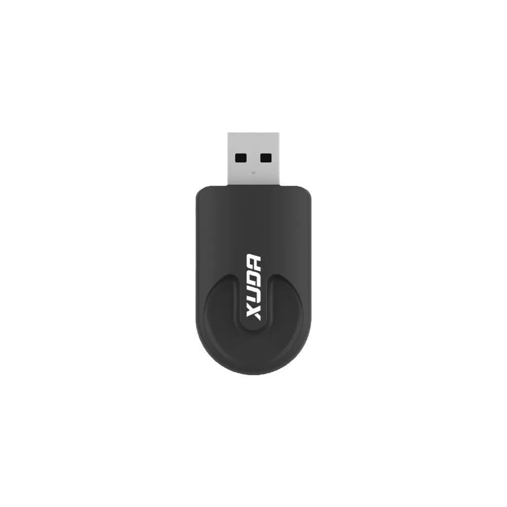 Small black Carplay USB wireless data adapter dongle on a car dashboard