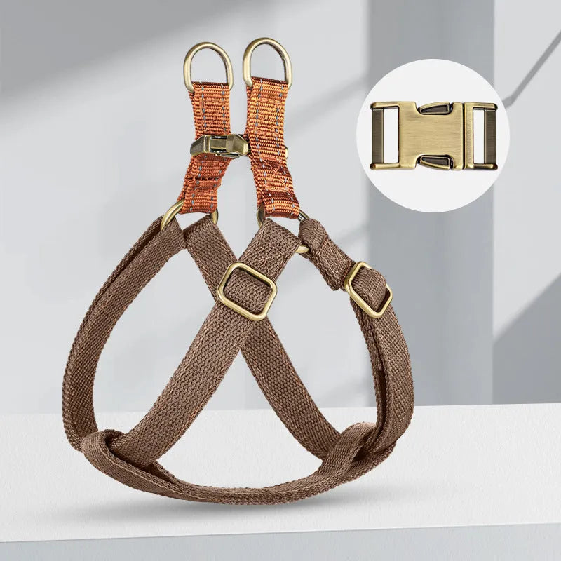Brown vest-style dog leash harness on small dog showing cotton nylon construction and alloy fastener