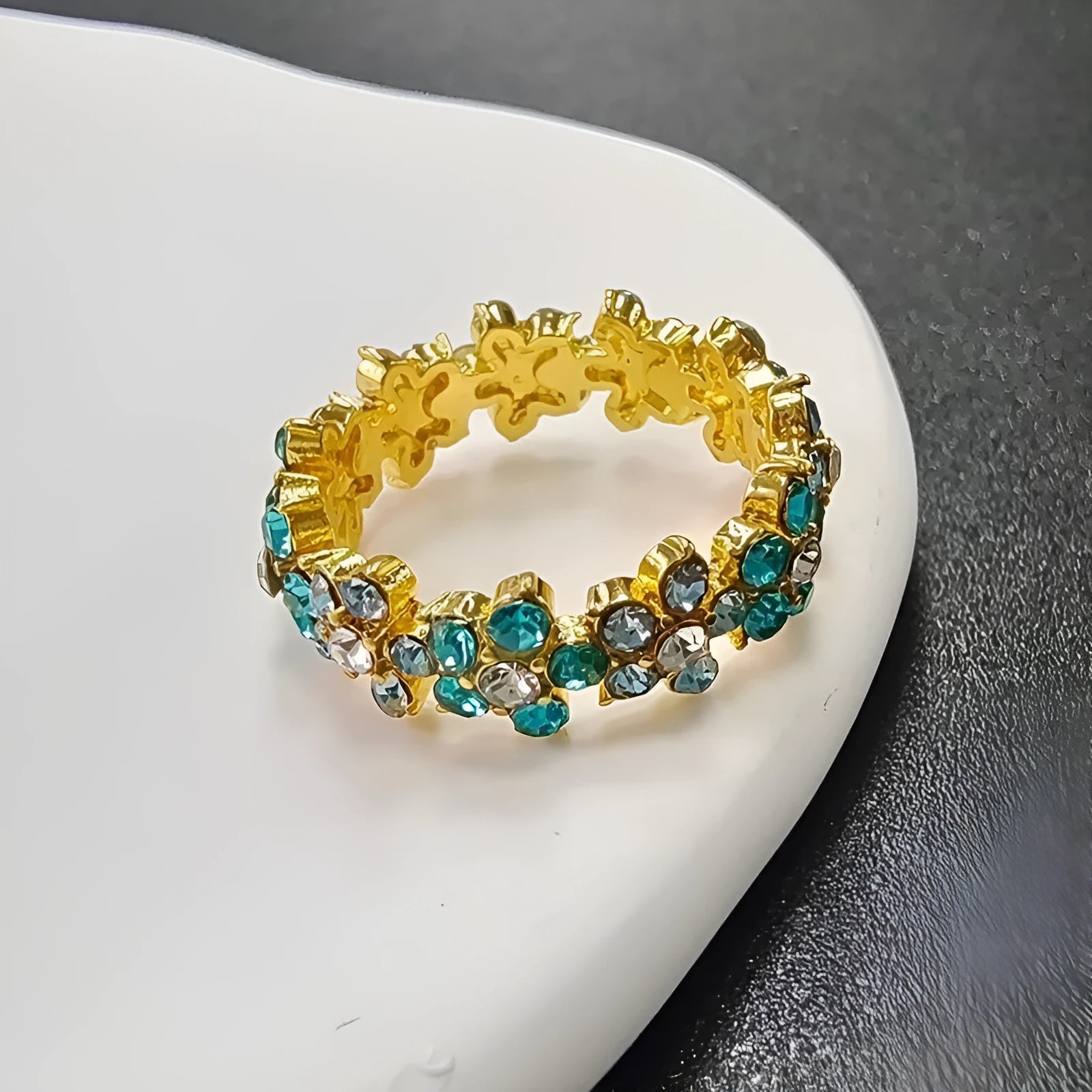 Gold or silver tone alloy elephant ring with a full diamond accent on the band.