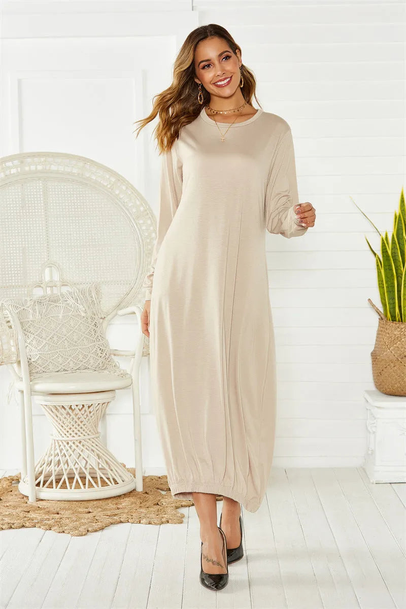 Loose-fitting black lantern dress with a crew neck and lace-up front detail on a mannequin.