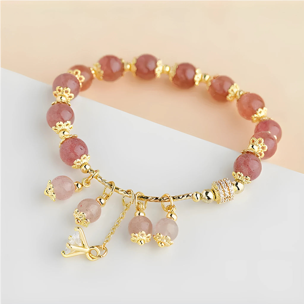 Women's pink crystal bracelet with heart-shaped design and pearl accents in strawberry quartz colour