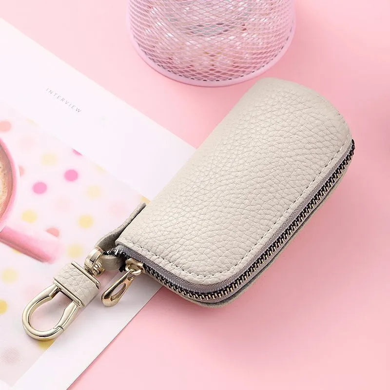 Men's fashion simple black PU leather zippered key ring case on a grey background.