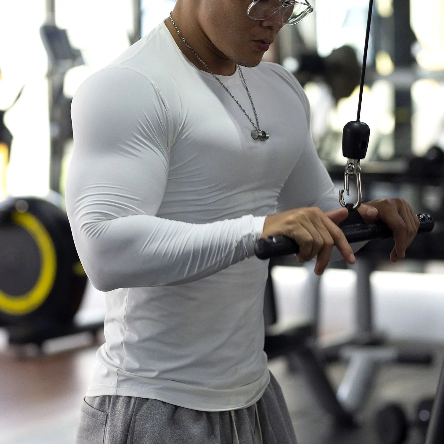 Man wearing a black slim-fit long-sleeved fitness top for running or gym workouts.