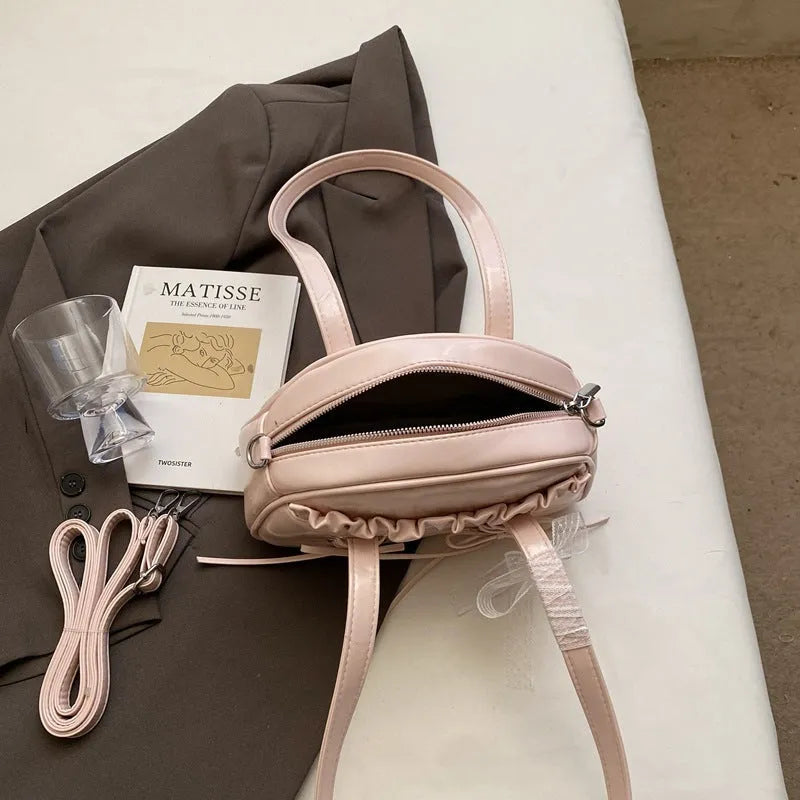 Women's casual PU shoulder handbag with a bandage bow and internal phone pocket in beige, black, blue, or pink.