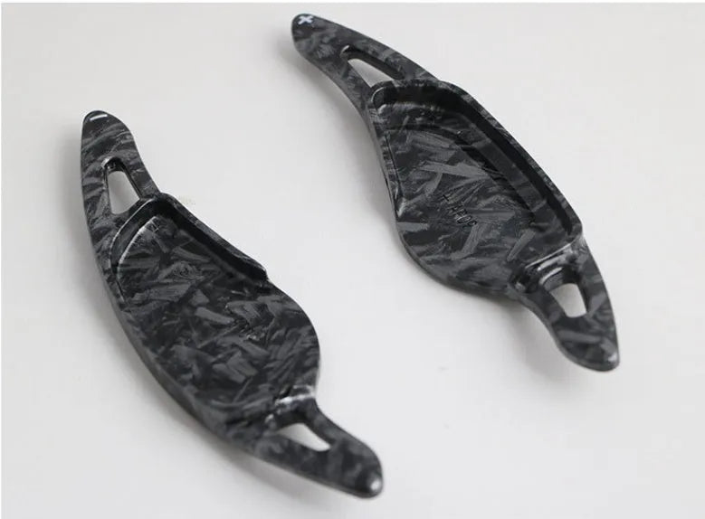 Carbon fibre pattern steering wheel paddle shifters in black and red finishes